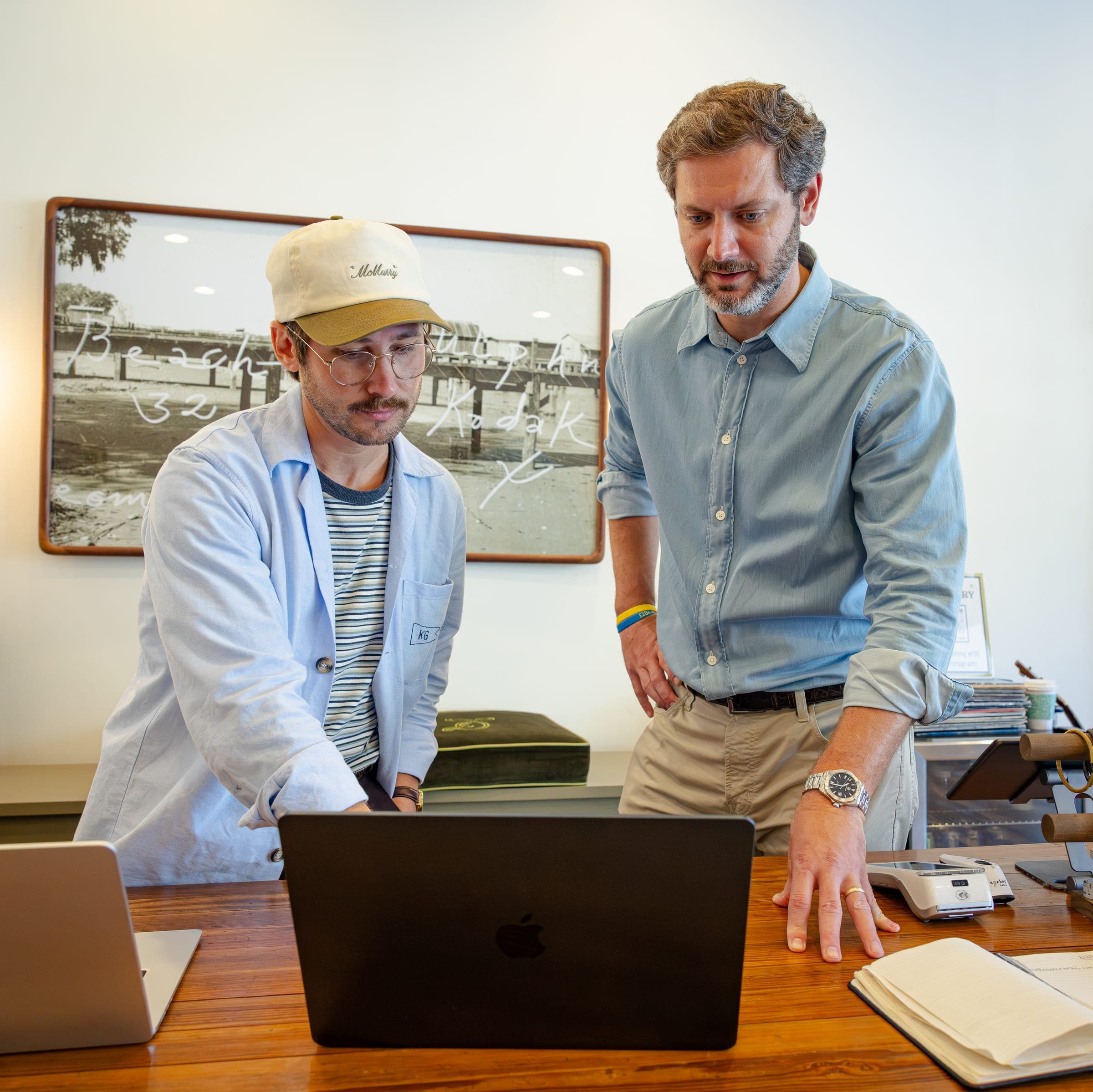The Ease Co working with a store owner at a laptop